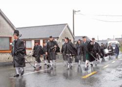 On Achill Island in Co. Mayo, members of a traditional pipe band braved rain and wind to carry out the annual parade on St. Patrick’s Day.